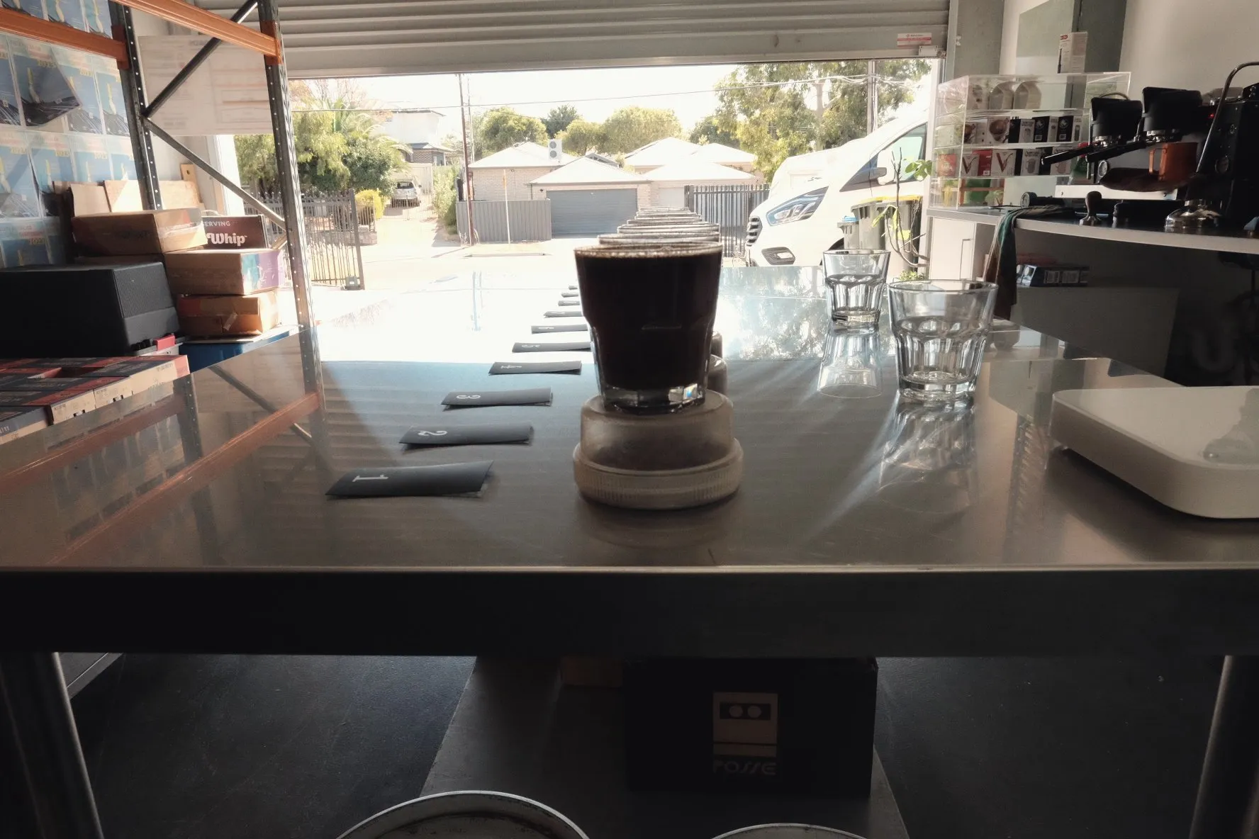 A brewed coffee sample in a glass