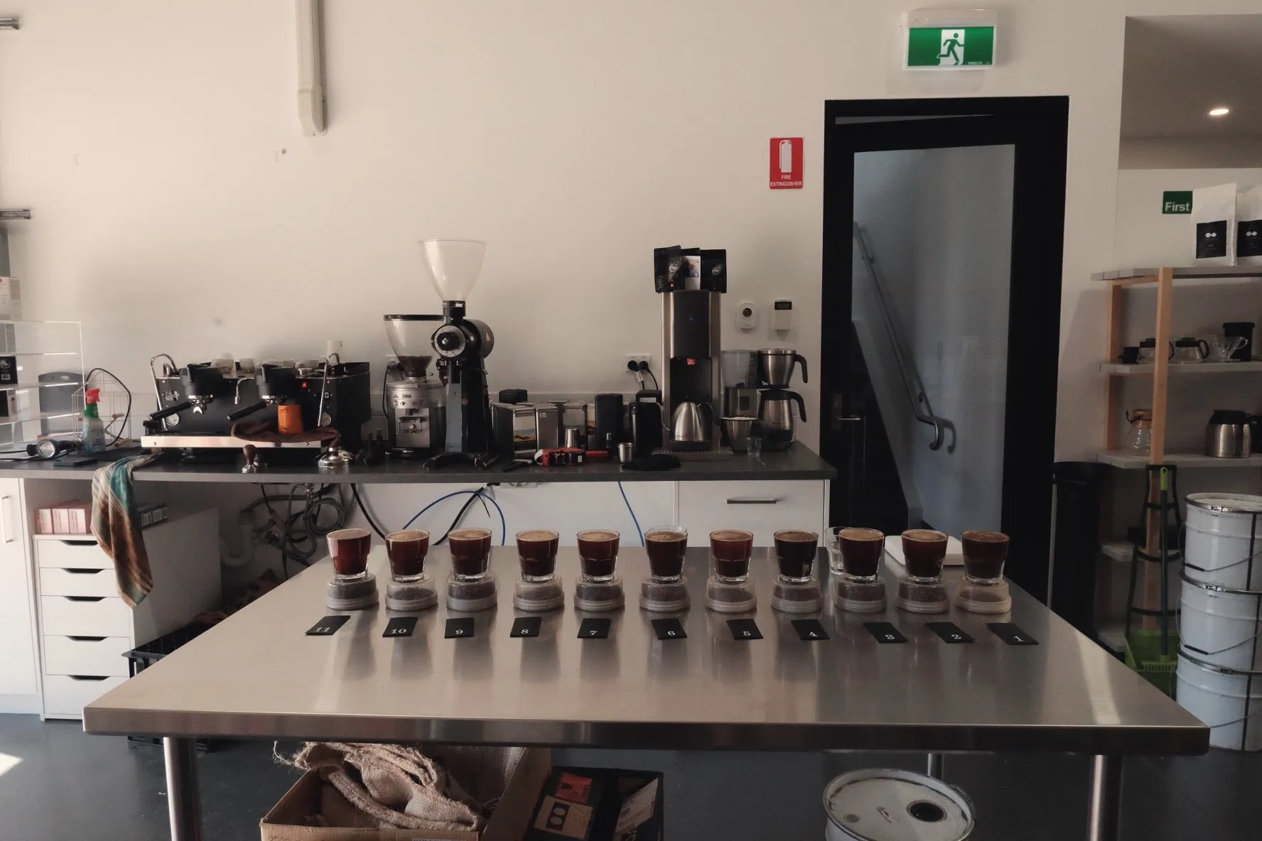 A tasting table covered in coffee samples