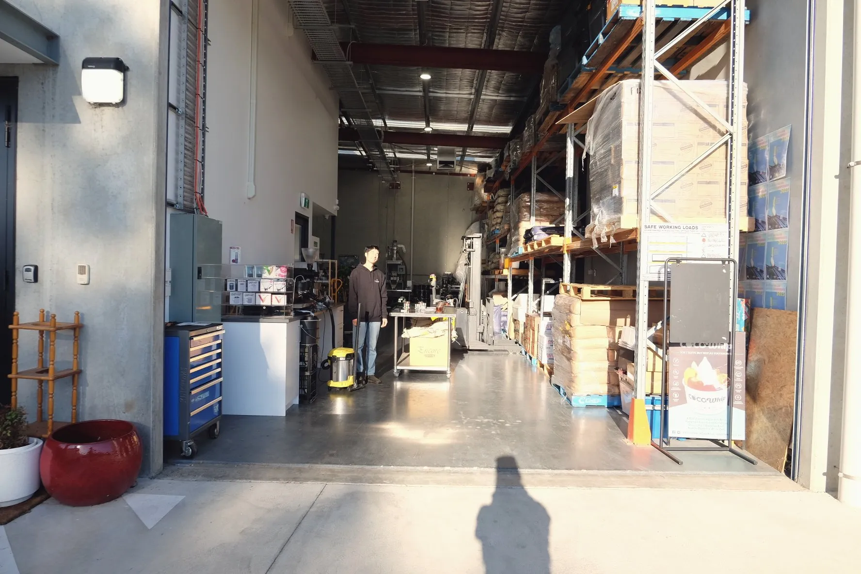 A sunlit corridor inside a warehouse roastery